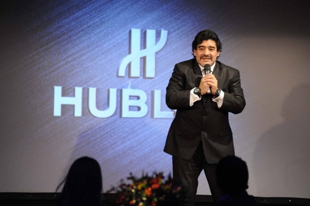 Diego Maradona showing off his both Hublot King Power Maradona watches 716.CI.1129.RX.DMA11 716.OM.1129.RX.DMA12 front .jpg